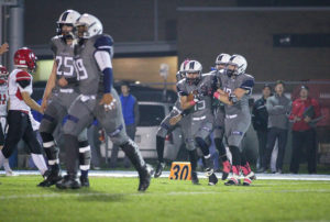 ANGIE FORREST PHOTO - The Clinton Topper. Connor Mullooly and his defensive teammates celebrate after an early fumble recovery.